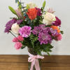 The Radiant Melody Arrangement is a vibrant and captivating display, elegantly showcased