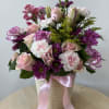 Presented in a lovely white basket, this bouquet features a graceful mix