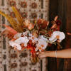 -  Bridal bouquet showcasing warm and peach tones
- Earthy, organic arrangement