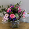 Beautiful vase bouquet filled with roses, assorted flowers and succulent.