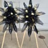 This elegant sympathy black and gold standing spray set consists of 2