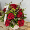  This arrangement of deep red roses nestled in a white basket