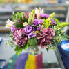 This arrangement features premium hydrangea, stargazer lily, purple lisianthus, green dianthus, and