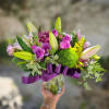 This arrangement features premium hydrangea, stargazer lily, purple lisianthus, green dianthus, and