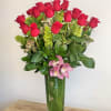 A modern twist on the classic rose display! One dozen premium long