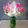 This feminine arrangement features a variety of springy flowers in shades of
