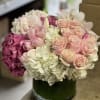 A luxurious, mix of roses, hydrangea, tulips and exotic Cymbidium Orchid blooms