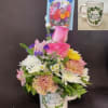 A cute arrangement in a keepsake coffee mug is made of roses
