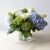 Clear Glass cylinder filled with Blue and Green Hydrangea and accented with