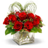 Dozen gorgeous red roses in cube vase accented with bear grass Heart....Show