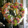 Open heart with clusters of roses, hydrangea, and ranunculus. Dimensions: 30-36 in