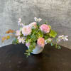 A loose, free flowing arrangement crafted with ranunculus, sweet pea, hellebore, and