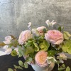 A loose, free flowing arrangement crafted with ranunculus, sweet pea, hellebore, and