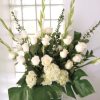 An all white tribute, this funeral basket is pure and tranquil. Featuring