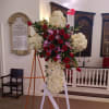 This spray contains: roses and carnations.   Custom prices are higher.