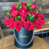 Two dozen imported red roses with touches of green and a personalized