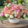 Embrace the beauty of lavish rose garden arrangement. These enchanting flowers bring