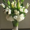 This all white classy arrangement is designed in a trumpet vase with
