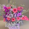 This vibrant and eye-catching arrangement features an irresistible color combination that is