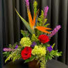 This Arrangement includes Purple Liatris, Bird of Paradise, Red Roses, Green Hydrangea