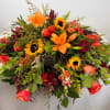 Experience the essence of fall with our vibrant casket spray, a symbol