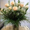 Large vase arrangement of 18 pale peach. cr&egrave;me roses arranged in a