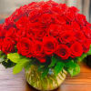 A dramatic abundance of roses. 100 stems presented in a tight cluster
