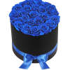 A modern flower arrangement in a black cylinder box filled with blue