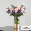  Featuring a vibrant Lisianthus and pink Roses is a true work