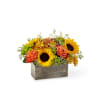 A weathered wooden rectangular box with garden flowers - sunflower, roses, button