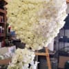 A heart shaped standing spray with an extended bottom filled with roses