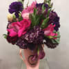 This stunning arrangement inside a beautiful pink vase comes with an array