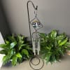 Double stained glass wind chimes with words of sympathy on the metal