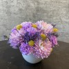 A petit arrangement with mums, craspedia, and dianthus. 