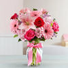 Arrangement with a classic pink bow comes with pink gerbera daises, pink