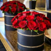 Capturing love in every petal.  Red roses in sleek black hatboxes