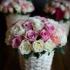 Pink and white roses, elegantly arranged in a basket. Our stunning flowers
