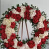 Open wreath with red roses and white hydrangeas. 