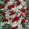 Spray with red roses, white hydrangeas, and white lilies.