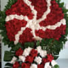Closed wreath with red and white roses.