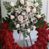 Open wreath with red roses, white roses, and white lilies.
