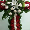 Cross with red and white roses and white lilies.