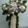 Cross with white hydrangeas, white lilies, and white roses.