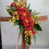 Bamboo cross with orange orchids and red roses.