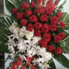 Spray with red roses, white hydrangeas, white lilies, and red gladiolus. 