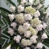 Spray with white roses, white hydrangeas, and calla lilies.