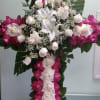 Cross with white and hot pink roses, and white lilies.