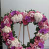 Open heart with white hydrangeas, pink spray roses, pink roses, purple orchids