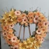 Open heart with yellow lilies, peach gerbera daisies, peach roses, and peach