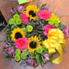 This colorful wreath with Sunflowers, Carnations, Green button poms and more is